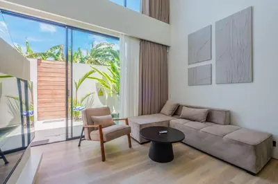 a living room with a couch and a table at Layur Villa in Canggu
