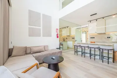 a living room with a couch and a table at Layur Villa in Canggu