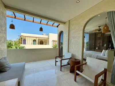 a bedroom with a view of a bed and a mirror at Luxury Berawa Private 3BR Villa With Butler in Canggu