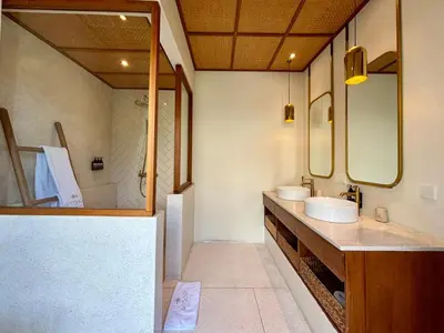 a bathroom with two sinks and a large mirror at Luxury Berawa Private 3BR Villa With Butler in Canggu