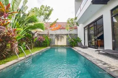 a swimming pool in the backyard of a house at Villa Ayu in Kerobokan