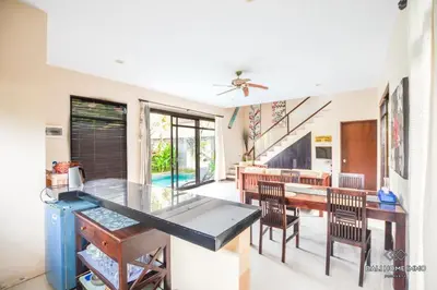 a kitchen and dining room with a table and chairs at Villa Ayu in Kerobokan