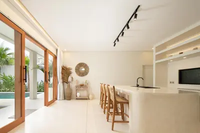 a kitchen and dining room with a table and chairs at Alegria De La Casa Seminyak in Seminyak