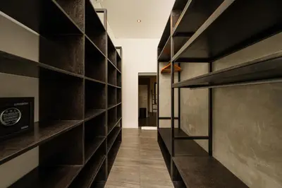 a hallway with dark wood shelves in a room at Elegant Modern 4BR Retreat in the Heart of Berawa in Canggu