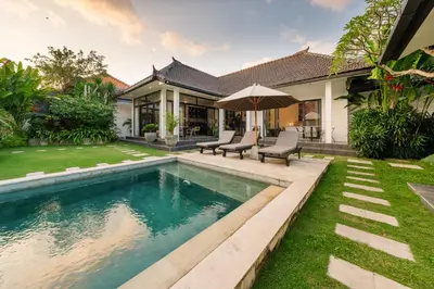 a swimming pool in the backyard of a house at Elegant Modern 4BR Retreat in the Heart of Berawa in Canggu