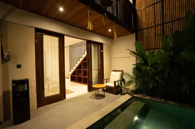 a house with a swimming pool in the middle of a room at De Awan Villa in Kerobokan