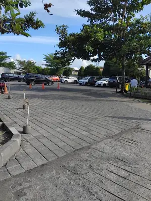 a parking lot with cars parked in a parking lot at Sweet Condo in Seminyak