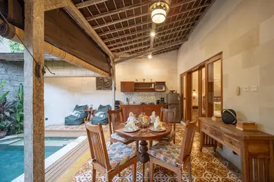 a dining room and kitchen with a table and chairs at Villa Gema Asri - Boho Chic Oasis in Central Petitenget in Seminyak
