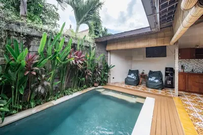a swimming pool in a backyard with plants at Villa Gema Asri - Boho Chic Oasis in Central Petitenget in Seminyak