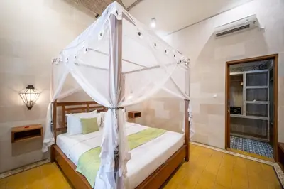 a bedroom with a bed with a canopy at Villa Gema Asri - Boho Chic Oasis in Central Petitenget in Seminyak