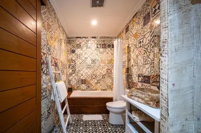 a bathroom with a tub and a toilet and a sink at Villa Gema Asri - Boho Chic Oasis in Central Petitenget in Seminyak