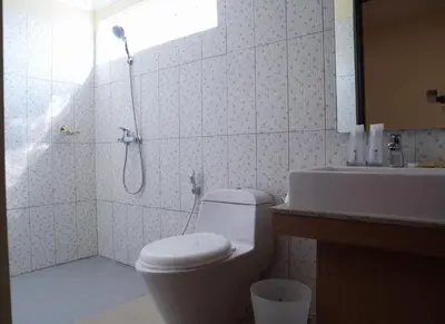 a bathroom with a shower and a toilet and a sink at Sunrise Aventus Villa Nusa Dua in Nusa Dua