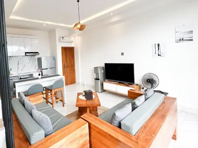 a living room with a couch and a tv at Villa Arti in Seminyak