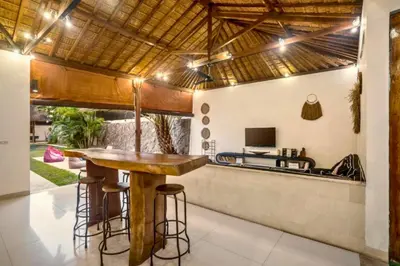 a kitchen with a bar in a villa at Davion 6 BR Private Pool Villa in Seminyak