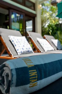 a couple of lounge chairs sitting on a table at 4-Bedroom Villa - Large swimming pool - Ideal place for friends and families in Seminyak