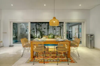 a dining room with a table and chairs at Villa Meya 3 Bedroom Villa in Central Seminyak in Seminyak