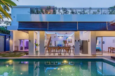 a villa with a swimming pool and a house at Villa Kanari,5 bed & pool in Seminyak