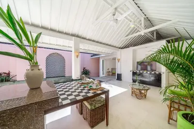 a living room with a table and some plants at Ocean Two 4BR Family Retreat Oberoi in Seminyak