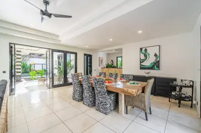 a dining room and living room with a table and chairs at Ocean Two 4BR Family Retreat Oberoi in Seminyak