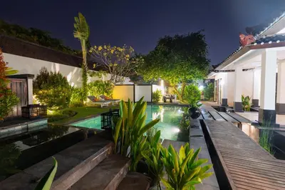 a swimming pool in the backyard of a house at night at Ocean Two 4BR Family Retreat Oberoi in Seminyak