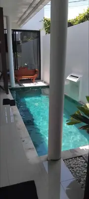 a swimming pool in the middle of a house at Serene Bali Villa with Private Pool and Antiqued Charm in Balian
