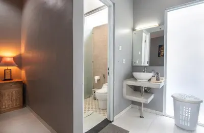 a bathroom with a toilet and a sink and a mirror at Villa Goodison - Two Bedrooms in Legian