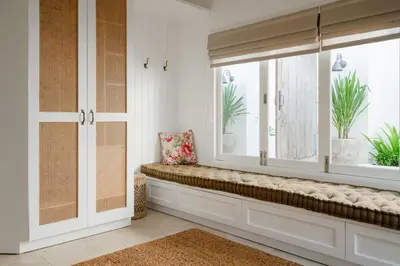 a window seat in a room with a window with plants at Luxurious & Bespoke Upscale 3BR Villa in Canggu in Canggu