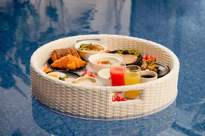 a basket filled with food and drinks on a table at Kinama Villa Jimbaran Bali in Jimbaran