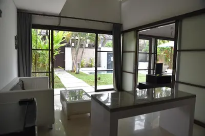 a living room with a table and a couch at Casa Veluna - Seminyak in Seminyak