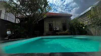 a large blue swimming pool in front of a house at 2 Bedrooms Private Pool Villa Indi K Kerobokan in Seminyak