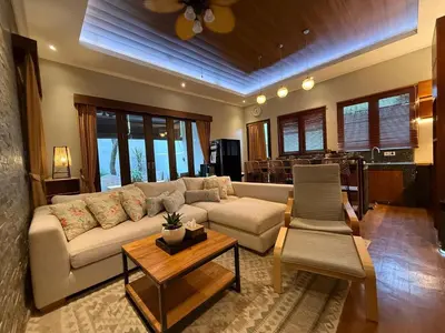 a living room with a couch and a table at Villa Jiwanta by Maheswara in Kerobokan