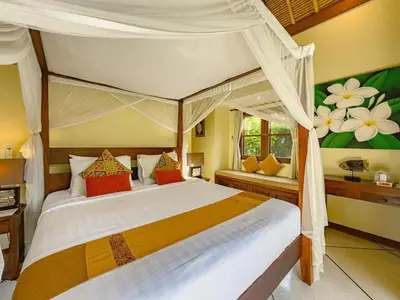 a bedroom with a large bed with a canopy at Luxury 4BR - Villa Santai - Central Seminyak in Seminyak