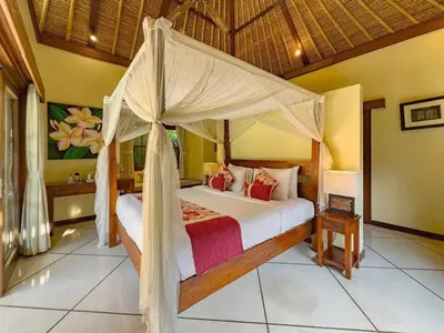 a bedroom with a bed with a canopy at Luxury 4BR - Villa Santai - Central Seminyak in Seminyak