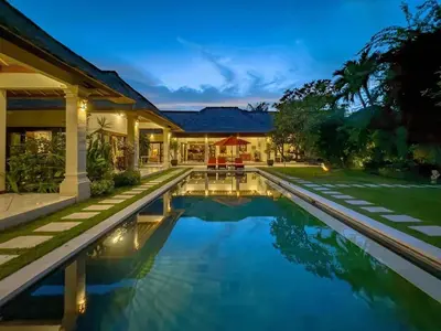 a swimming pool in front of a house at Luxury 4BR - Villa Santai - Central Seminyak in Seminyak