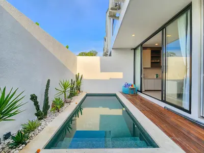 a swimming pool in the backyard of a house at Villa Sorano Seminyak by Nagisa Bali in Seminyak