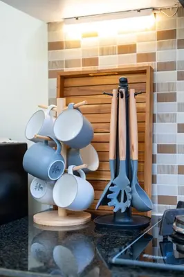 a bunch of utensils hanging on a kitchen counter at Prime Location Seminyak 3BR Pool Villa in Seminyak