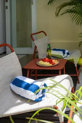 a table with a plate of fruit and a bottle of wine at Prime Location Seminyak 3BR Pool Villa in Seminyak