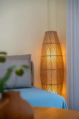 a bedroom with a bed with a lamp next to it at Prime Location Seminyak 3BR Pool Villa in Seminyak