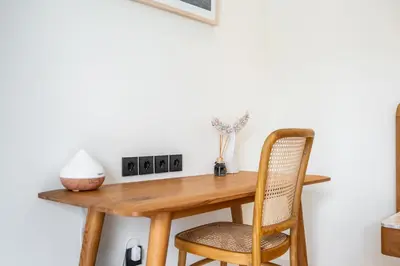 a wooden table and two chairs in a room at Jivani Villa - 9 min to Nusa Dua Beach - Brand New, Cinema Room, BBQ, 3Bdr in Jimbaran