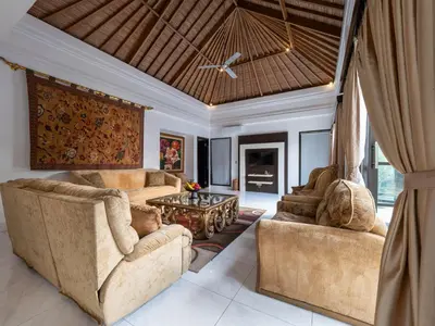 a living room with two couches and a table at Villa Cometa Luxury Seminyak by Adam Jyota Management in Seminyak