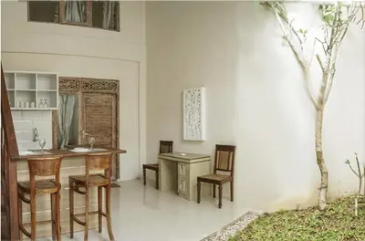 a kitchen with a table and chairs and a desk at Bali Balitung in Seminyak