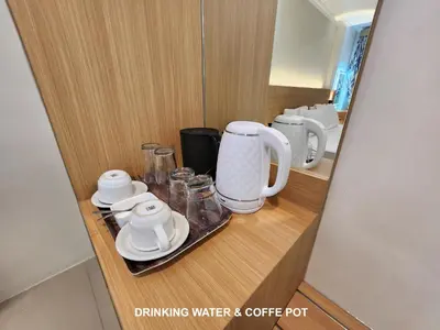 a cupboard with a coffee maker and cups on it at Bali Balitung in Seminyak