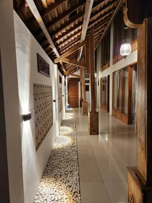 a hallway of a building with wooden ceilings at Bali Balitung in Seminyak