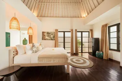 a bedroom with a large bed in a room at Stylish 3BR Escape, 5 Mins to Seminyak Beach in Seminyak