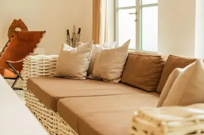 a brown couch with pillows in a living room at Stylish 3BR Escape, 5 Mins to Seminyak Beach in Seminyak