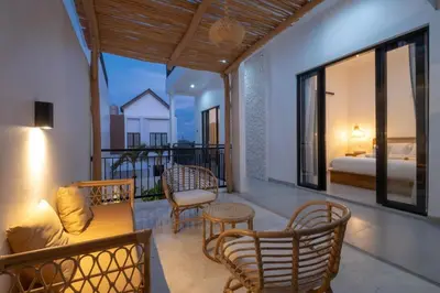 a room with a balcony with a bed and a room with a bed at La Casa Gomes in Nusa Dua