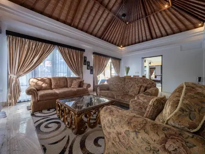 a living room with couches and a table at Villa Cometa Prime Seminyak by Adam Jyota Management in Seminyak