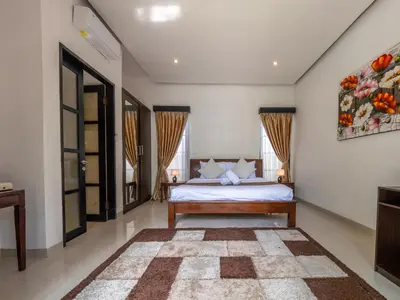 a bedroom with a bed and a rug at Villa Cometa Prime Seminyak by Adam Jyota Management in Seminyak