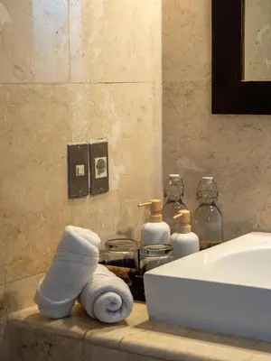 a bathroom with a towel on a counter next to a sink at Villa Cometa Prime Seminyak by Adam Jyota Management in Seminyak