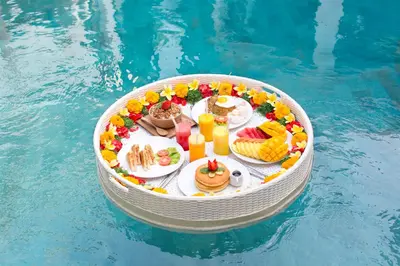 a table with food and drinks in a pool at Villa Mia Seminyak - Boutique Villas - I in Seminyak